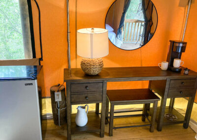 cozy cabin interior with wooden table lamp mirror fridge and coffee maker rustic decor inviting ambiance