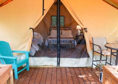 glamping tent interior cozy beds wooden deck nature retreat outdoor adventure luxury camping peaceful getaway