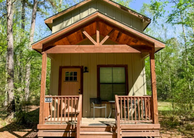 cozy rustic cabin in wooded setting with front porch surrounded by trees peaceful retreat nature getaway forest cabin