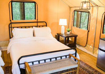luxurious glamping tent interior with cozy bed stylish lamp and scenic forest views perfect for nature getaway