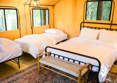 glamping tent with cozy beds rustic decor forest view serene retreat nature escape luxury camping comfort bedding