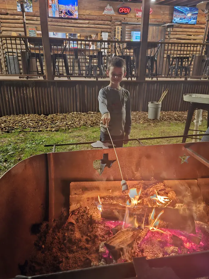 Kid heating marshmellows