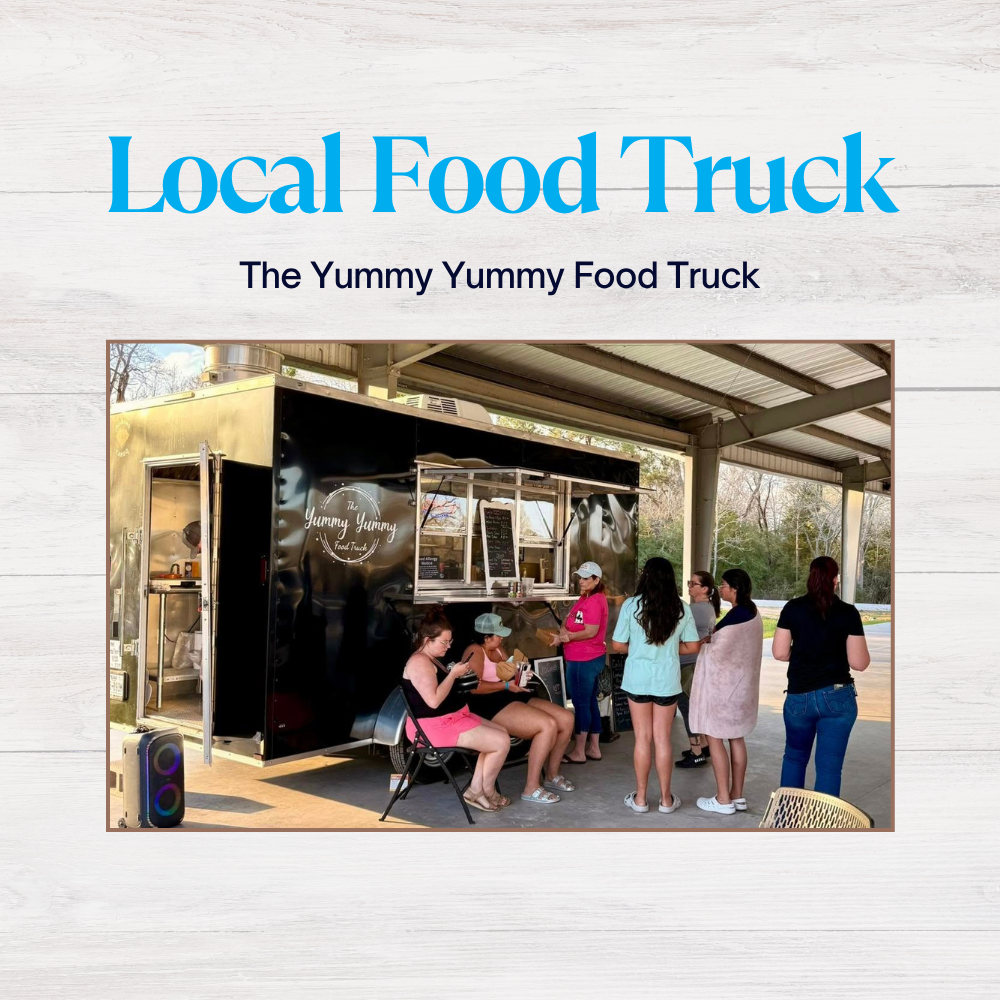 Local food truck with customers enjoying meals in front of Yummy Yummy black food truck under a metal canopy.