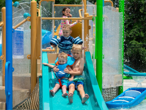 Kids splash pad and water slide at blue bayou bend | two creeks crossing resort kids splash pad and water slide at blue bayou bend