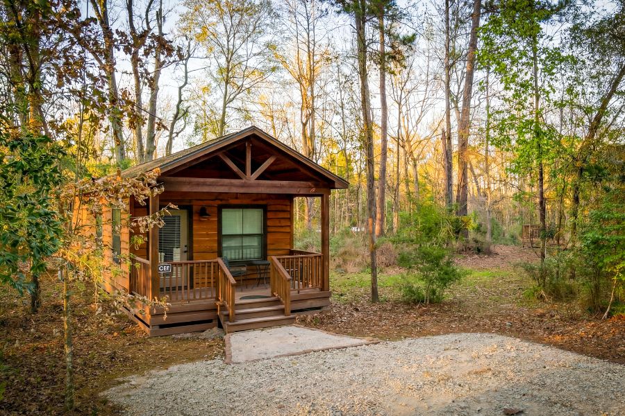 Cabin with a covered porch at Two Creeks Crossing Resort near Lake Livingston