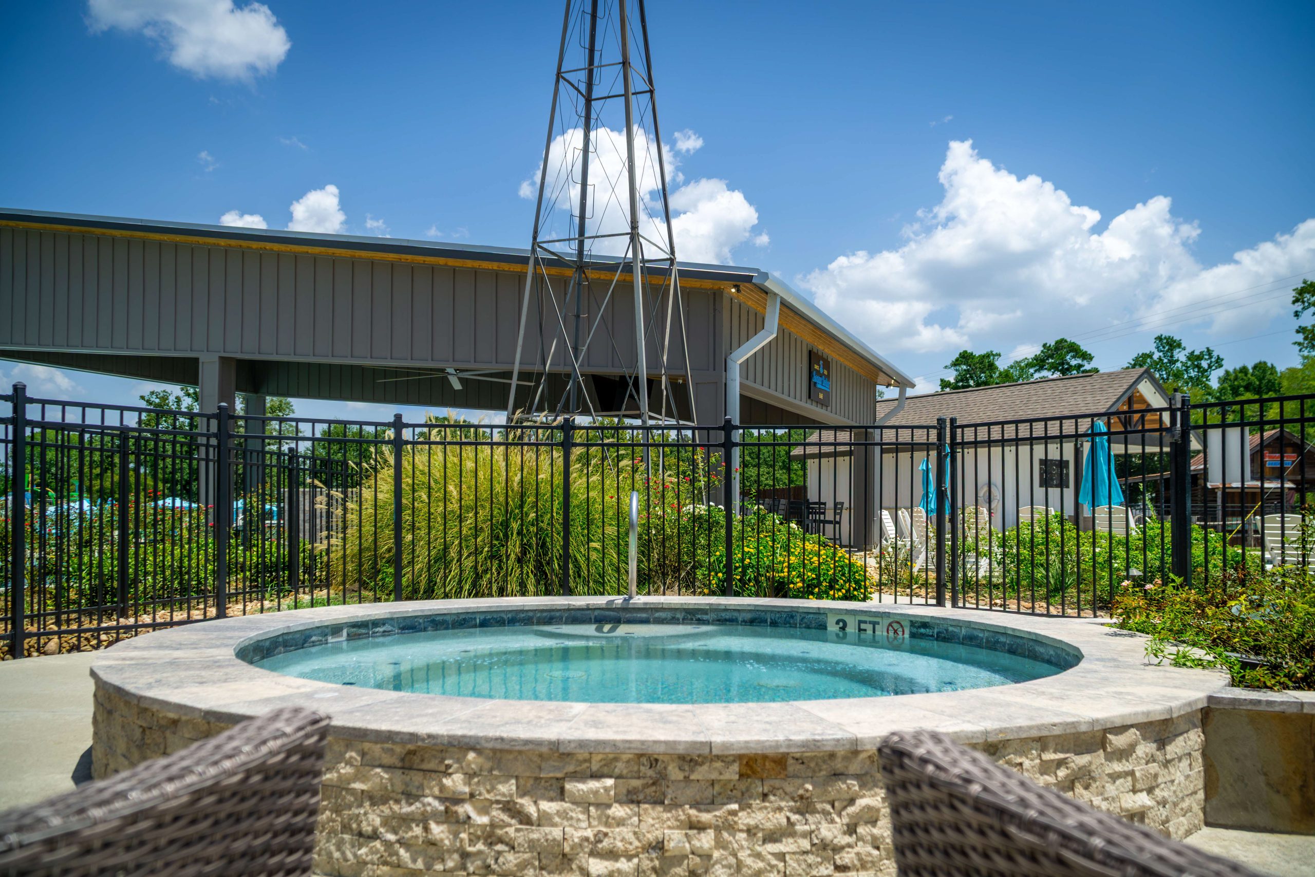 Shared hot tub beside the resort swimming pool at Two Creeks Crossing Resort